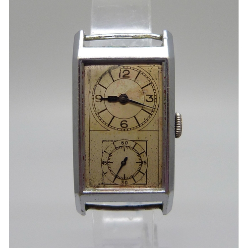 980 - A c1940's dual dial Swiss made wristwatch, 21mm wide case scratched and worn, lacking glass