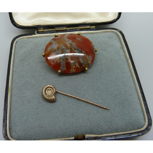 993 - A 9ct gold ammonite stick pin, 1.8g, and an agate set brooch