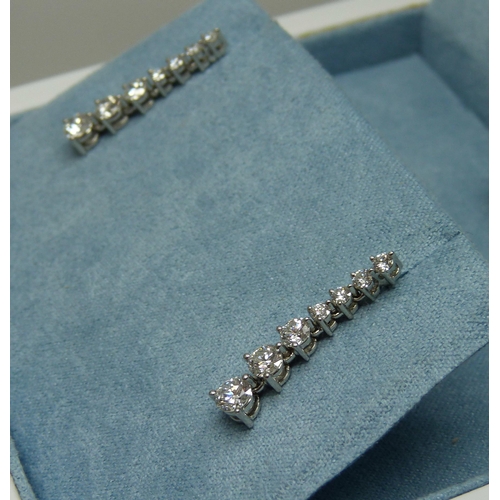 998 - A pair of platinum set diamond drop earrings, each set with seven diamonds, 1.26 carat total diamond... 