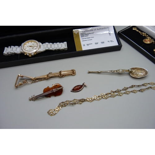 1100 - A silver spoon, a ruby ceramic watch with certificate, a silver and amber brooch and pendant and two... 