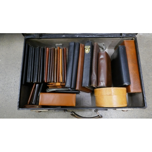 1112 - A collection of leather wallets, organisers, three shaving kits, etc., in a suitcase **PLEASE NOTE T... 