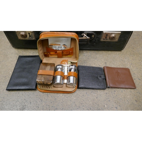 1112 - A collection of leather wallets, organisers, three shaving kits, etc., in a suitcase **PLEASE NOTE T... 