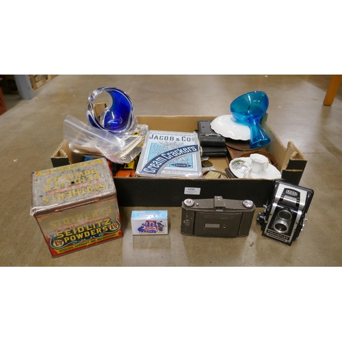 1152 - A box of assorted items including cameras, glassware, advertising tins, etc. **PLEASE NOTE THIS LOT ... 