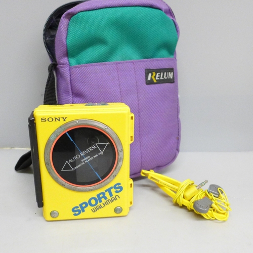 619 - A 1980’s yellow Sony Sports Walkman WM-75, battery operated, complete with matching headphones in pa... 