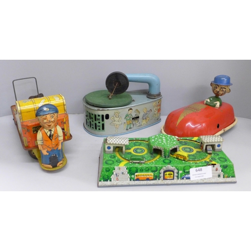 648 - Four tin-plate toys, Codeg clockwork car, clockwork luggage trolley, made in Gt. Britain, record pla... 