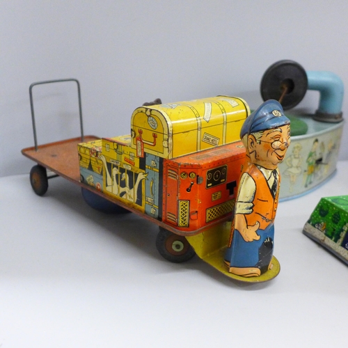 648 - Four tin-plate toys, Codeg clockwork car, clockwork luggage trolley, made in Gt. Britain, record pla... 