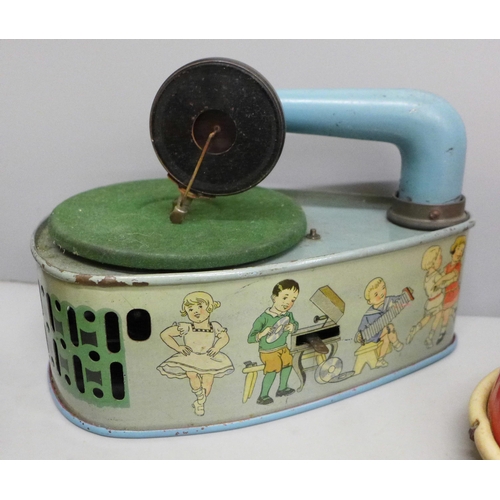 648 - Four tin-plate toys, Codeg clockwork car, clockwork luggage trolley, made in Gt. Britain, record pla... 