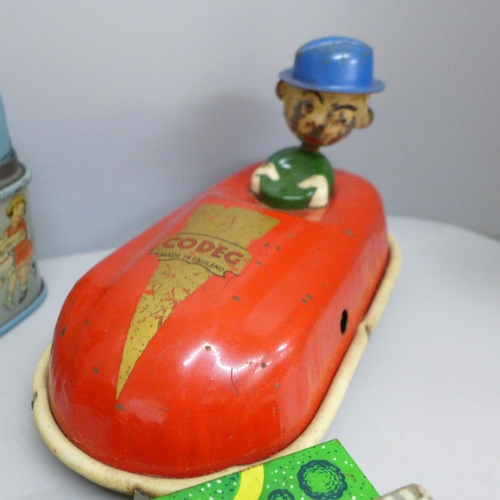 648 - Four tin-plate toys, Codeg clockwork car, clockwork luggage trolley, made in Gt. Britain, record pla... 