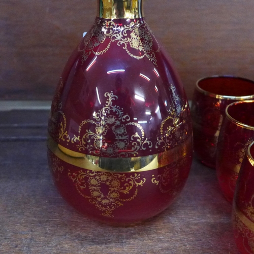 660 - A Ferro Lazzarini Italian Murano glass ruby red decanter set with 24ct gold overlay