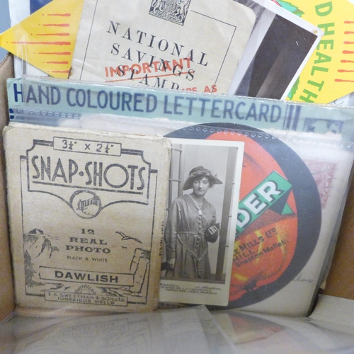 687 - A box of paper ephemera, maps, Vimto book, etc.