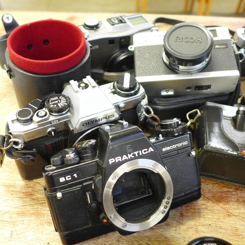 696 - Cameras and camera equipment, Olympus OM-1 x2, OM-2 body, OM 10 body, Ricoh 35 ZF, Praktica BC 1 bod... 