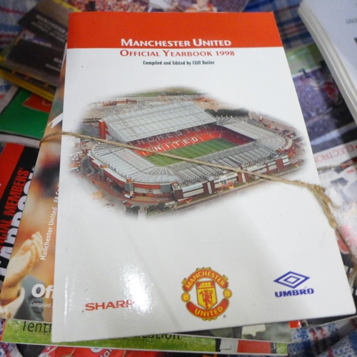 719 - A large quantity of Manchester United football programmes, year books, approximately 40 ticket stubs... 