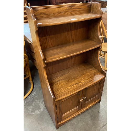 107 - An Ercol Golden Dawn elm bookcase