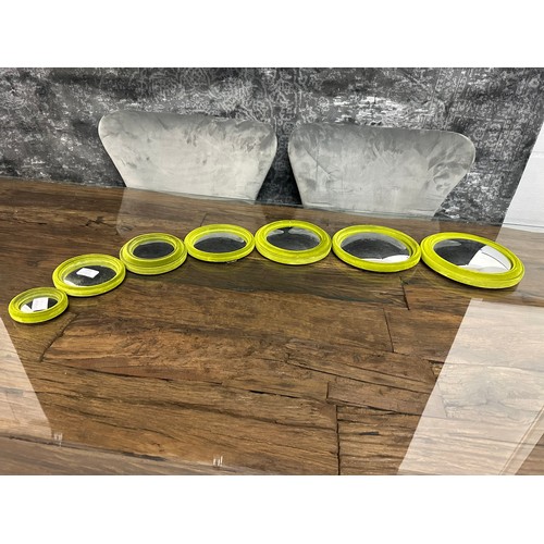 1332 - A set of seven green flocked convex mirrors