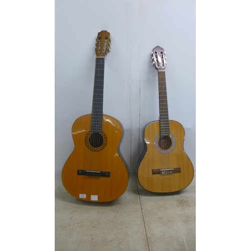 2050 - A Jose Ferrer El Primo 055815 classical acoustic guitar, one other acoustic guitar and a TGI soft gu... 