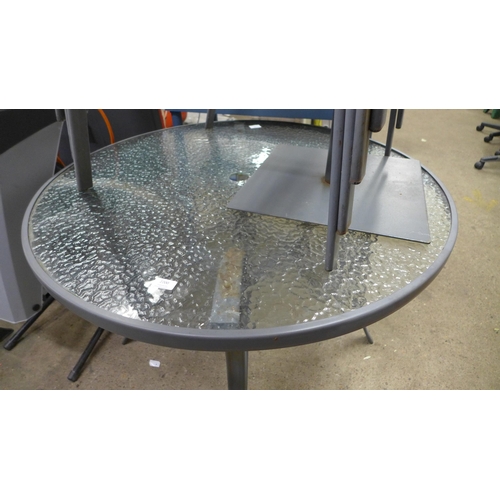 2200 - A metal and glass circular garden table with four chairs, parasole and base