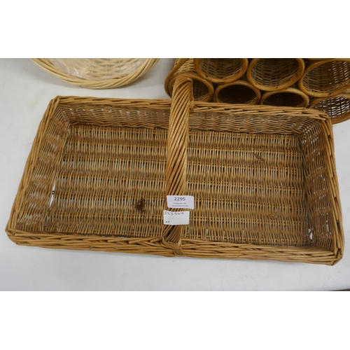 2295 - A selection of wicker items including hamper baskets and a wine rack