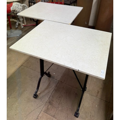 320 - A pair of cast alloy based pub table, with reconstituted marble top