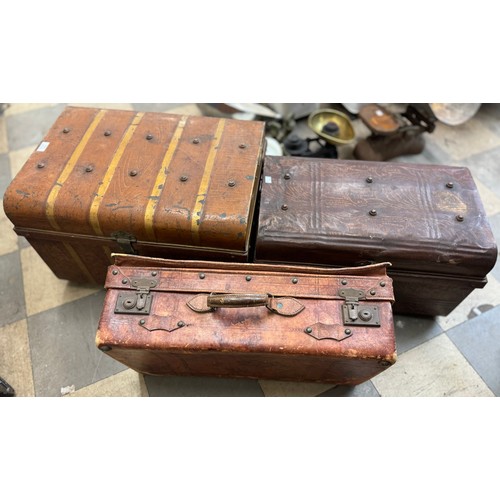 321 - Two early 20th Century tin steamer trunks and a leather suitcase