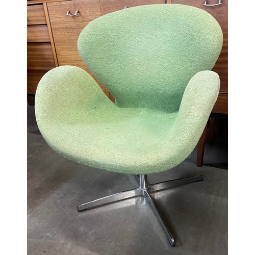 113 - An Arne Jacobsen style chrome and green fabric Swan chair