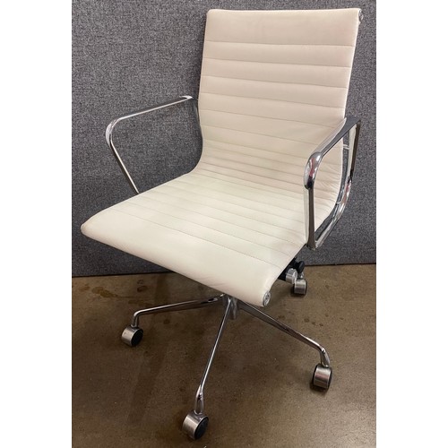 116 - An Eames style cream leather and chrome revolving desk chair