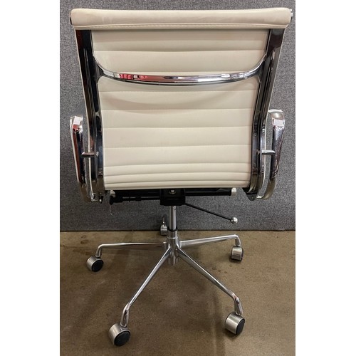 116 - An Eames style cream leather and chrome revolving desk chair