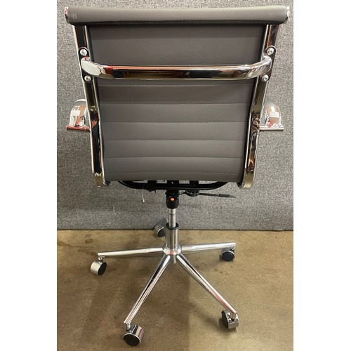 117 - An Eames style grey leather and chrome revolving desk chair