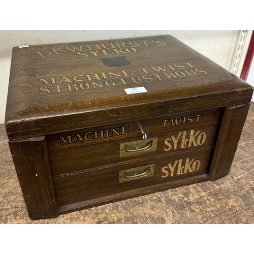 384 - An early 20th Century oak counter top cabinet, bearing  Dewhurst's Sylko inscription