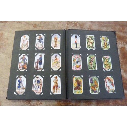 655 - A collection of cigarette cards, loose and in an album