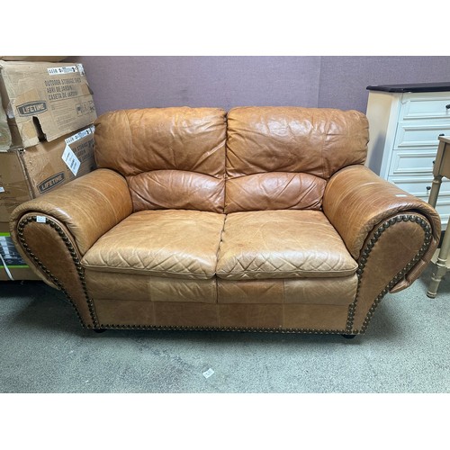 1467 - A brown leather two seater sofa