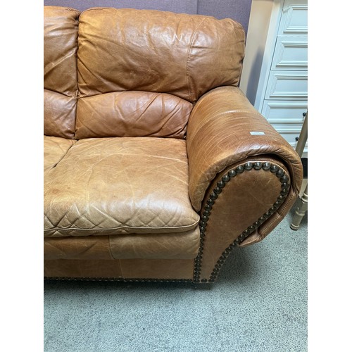 1467 - A brown leather two seater sofa