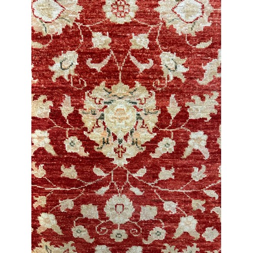 1514 - A hand woven all over floral design cream and auburn rug, 115 inch x 39.5 inch