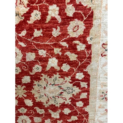 1514 - A hand woven all over floral design cream and auburn rug, 115 inch x 39.5 inch