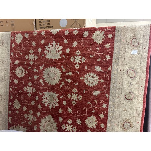 1515 - A hand woven all over floral design cream and auburn rug, 76 inch x 55 inch