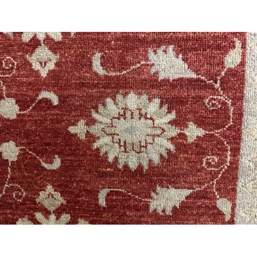 1515 - A hand woven all over floral design cream and auburn rug, 76 inch x 55 inch