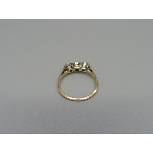 1015 - A 9ct gold, three stone synthetic white sapphire and diamond ring, 1.6g, L, shank marked 'Syn/W/Sapp... 