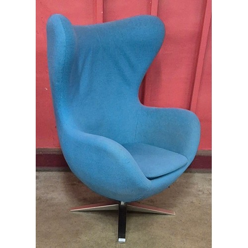 13 - An Arne Jacobsen style chrome and blue fabric upholstered revolving egg chair