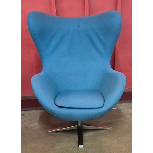 13 - An Arne Jacobsen style chrome and blue fabric upholstered revolving egg chair