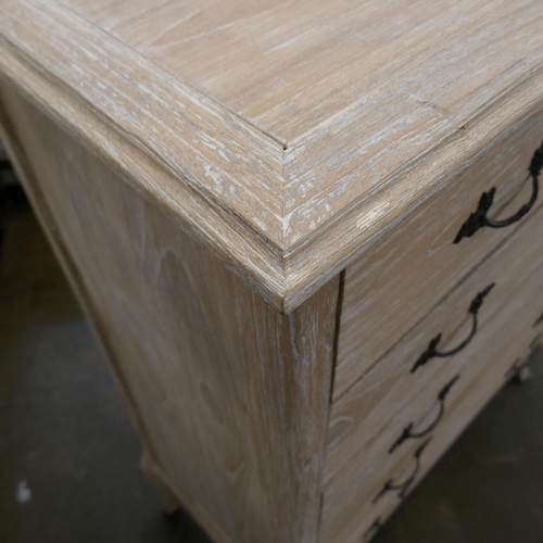 3058 - A limed ash chest of five drawers