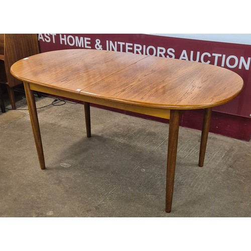 28 - A Meredew teak extending dining table