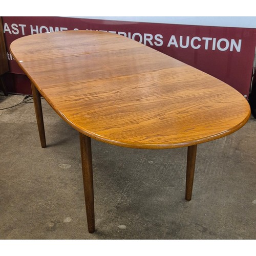 28 - A Meredew teak extending dining table