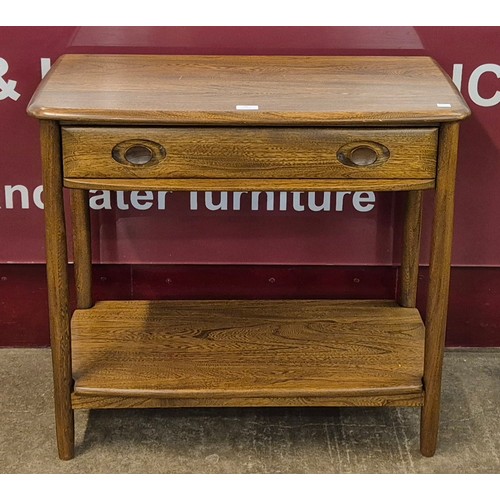 39 - An Ercol Golden Dawn ash single drawer console table