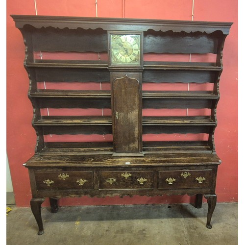 127 - A George III oak dresser, the Delft rack incorporating 30-hour clock, brass dial signed Nathaniel Re... 