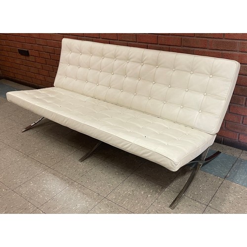 23 - A Barcelona style cream leather and chrome studio couch