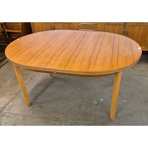 49 - An East German teak oval extending dining table