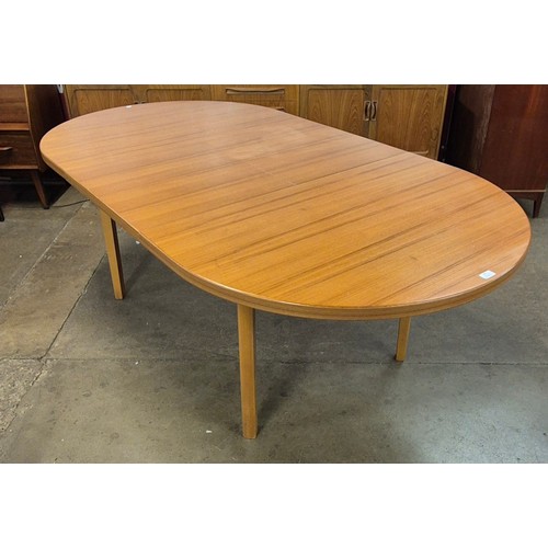 49 - An East German teak oval extending dining table