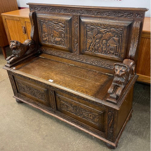 113 - A Jacobean Revival carved oak settle