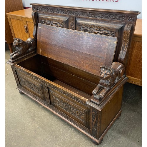 113 - A Jacobean Revival carved oak settle