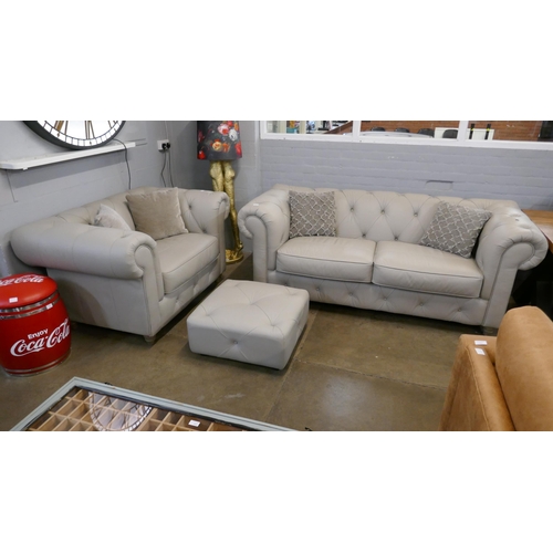 3015 - A stone leather Chesterfield three seater sofa, love seat and footstool RRP £2658