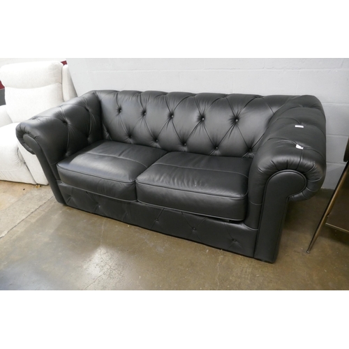 3067 - A black leather Chesterfield three seater sofa bed